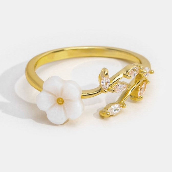 Miriam – Gold ring with white floral decoration.